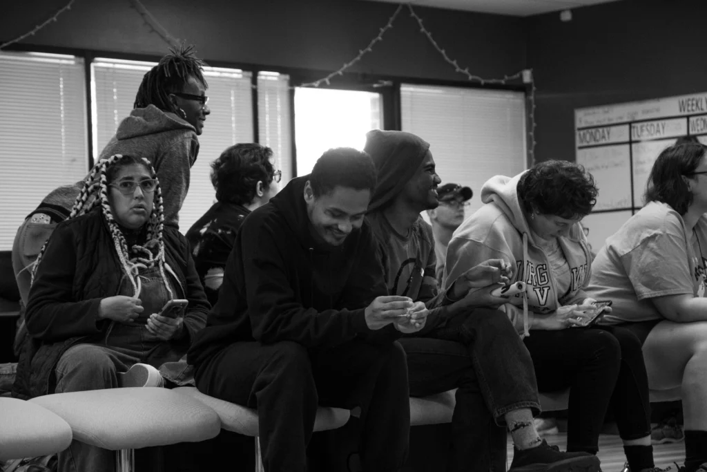 Adults sitting together during a candid group moment at an adult day support program.