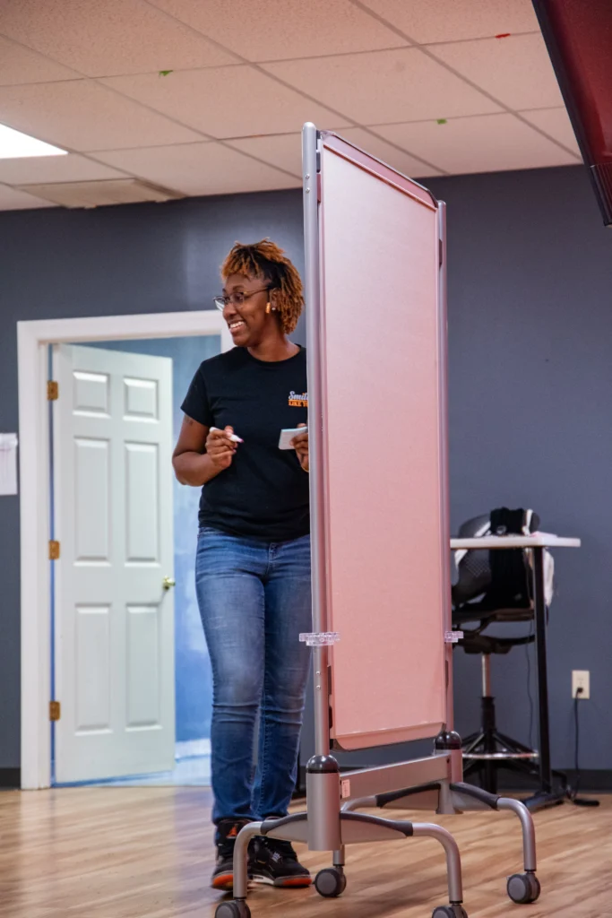 Adults laughing and talking together during a group activity at an adult day support program.