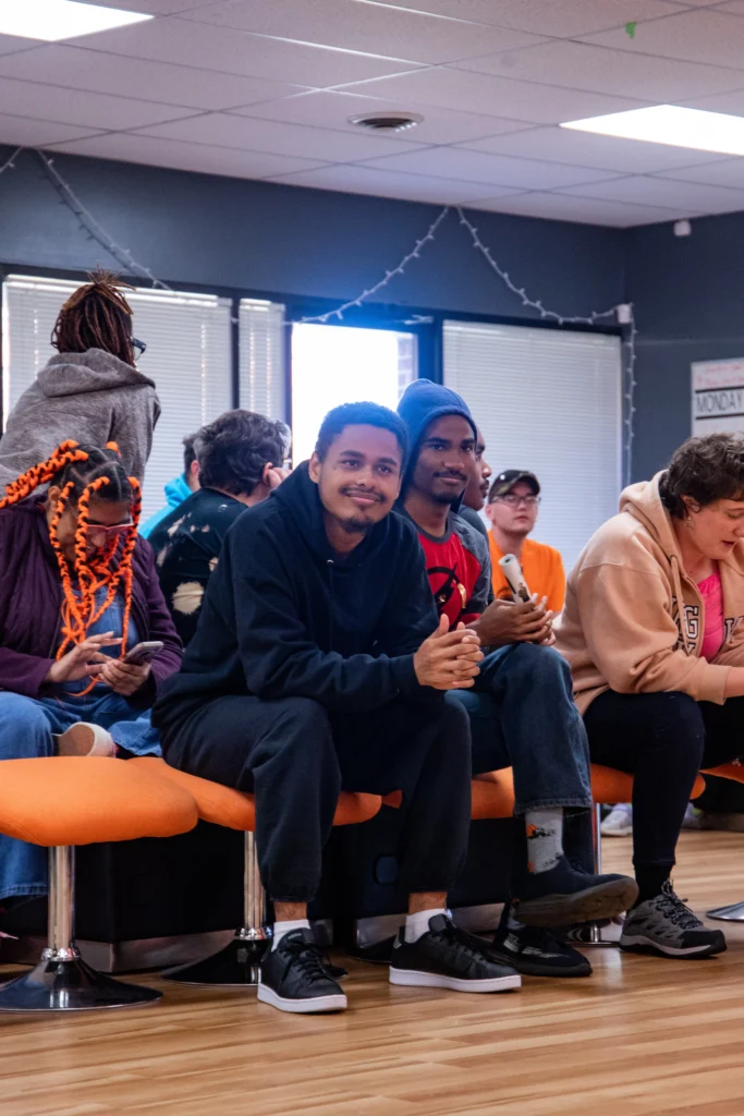 Adults sitting together during a group session at an adult day support program.
