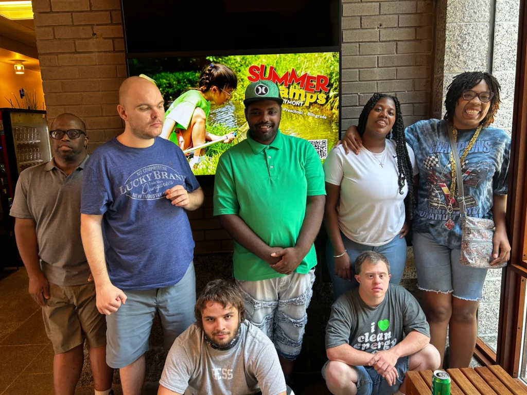 Adults with developmental disabilities gathering during a supported community outing in Richmond.