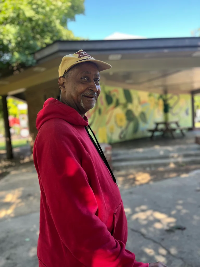 Adult member smiling during an outdoor park community outing.