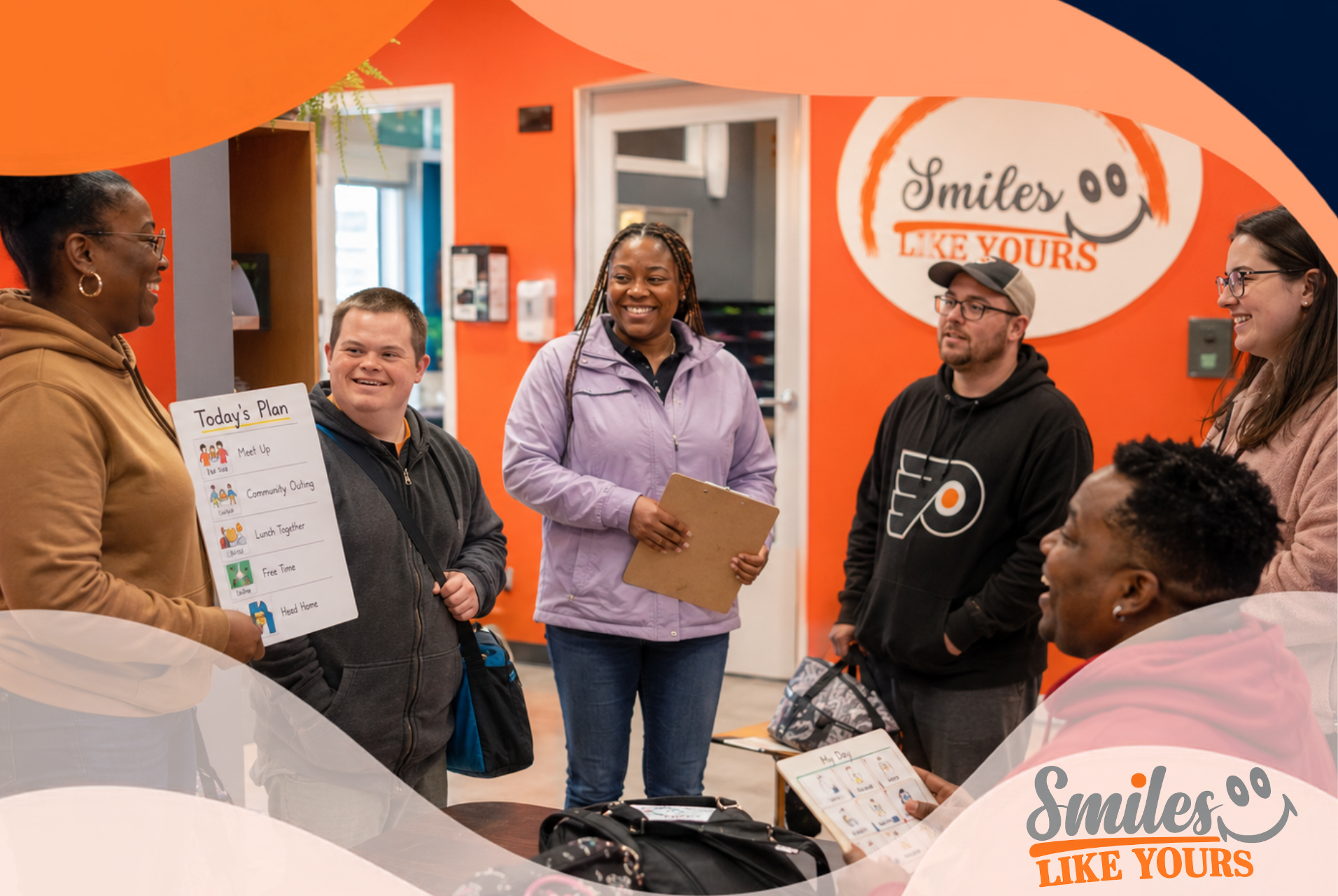 Smiles Like Yours participants and staff planning a community outing in a supportive group setting.
