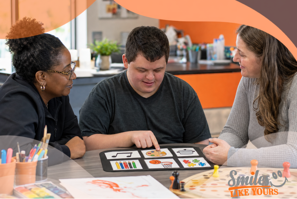 Adult with developmental disabilities using visual communication cards with support from Smiles Like Yours staff.