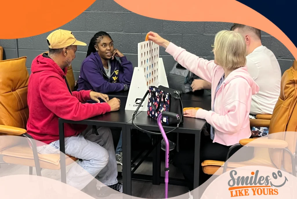 Adults with developmental disabilities participating in a social game activity at Smiles Like Yours.