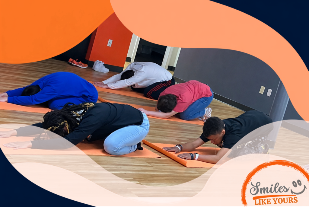 Adults with developmental disabilities stretching on yoga mats during a movement and wellness activity.