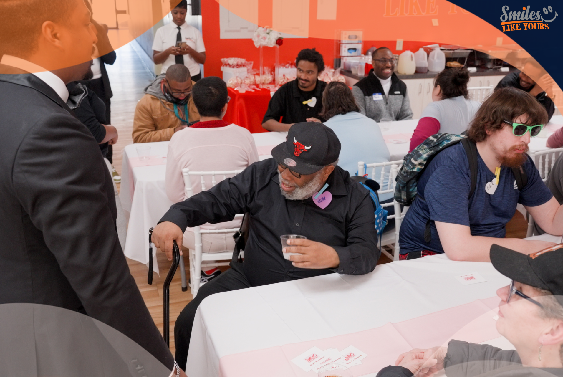 Adults talking and connecting during an inclusive Smiles Like Yours community event.