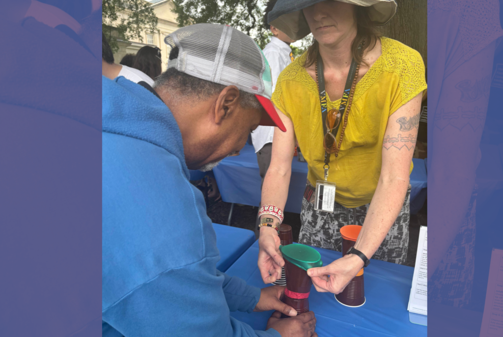 Adult participant completing a hands-on community activity with support from a staff member.