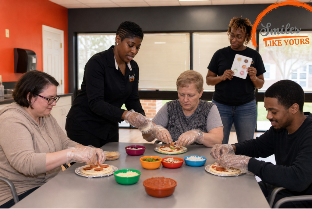 Smiles Like Yours staff supporting adults during a group cooking and life-skills activity.