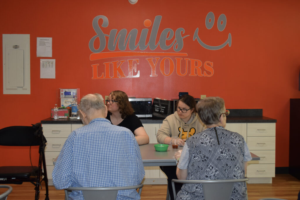 Adults participating in a group discussion at the Smiles Like Yours center in Richmond, Virginia.