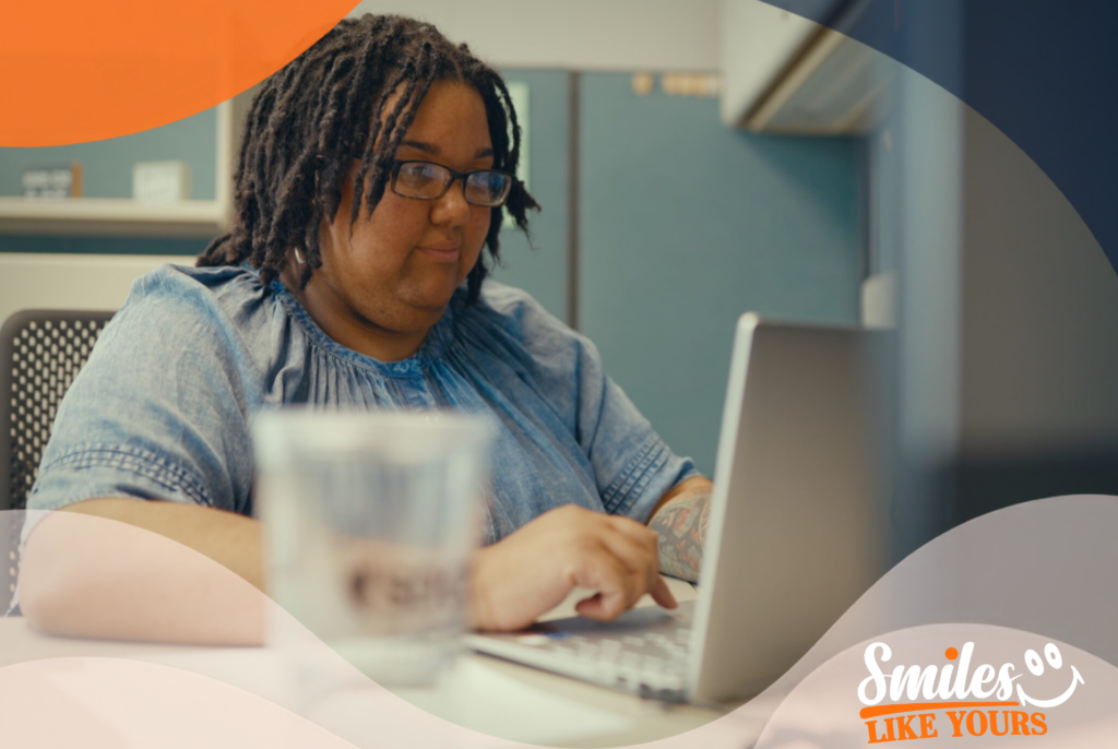 Adult using a laptop to manage savings and disability-related expenses.