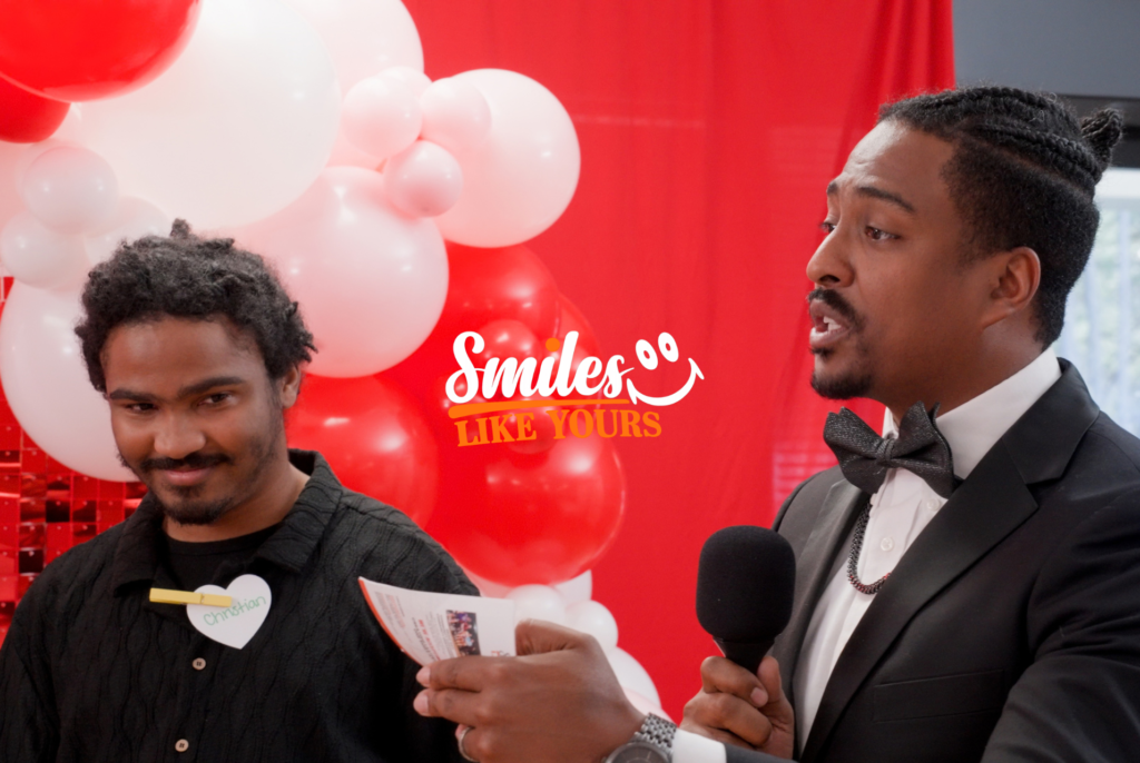 Adult participants use a smartphone and tablet during a Smiles Like Yours social event.